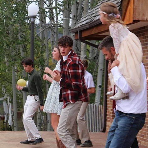 Family dancing on the lodge deck.