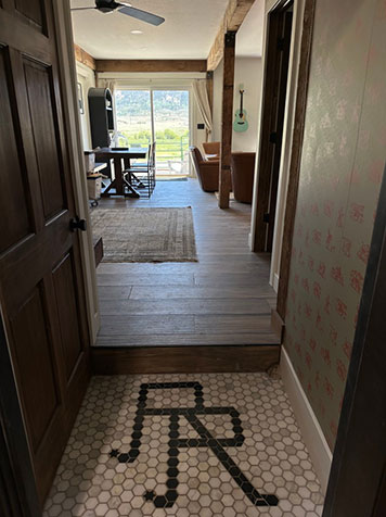 Rebel Ranch Tack Room Studio foyer with custom tile RR logo mark.
